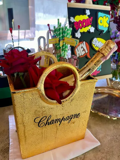 A stylish golden champagne bucket ready for service. I ensure all my bar equipment, from shakers to ice buckets, matches the aesthetic of your event.