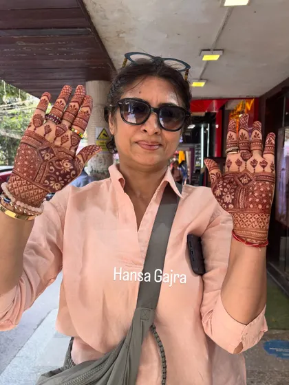 A happy mother showing her full-hand mehendi. It was a pleasure creating these memories and seeing her joy.