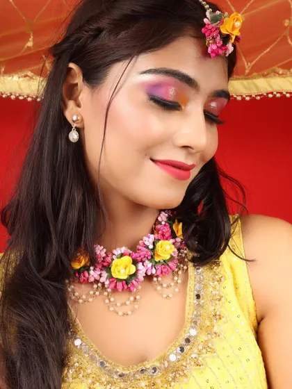 A vibrant and colorful Haldi makeup look. I used a blend of pink and yellow on the eyes to match the floral jewelry and the festive mood of the ceremony.