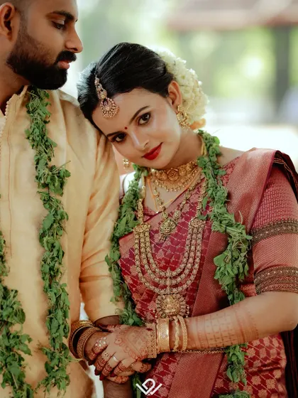 A classic portrait of a South Indian couple, capturing the elegance of their wedding attire and the quiet love between them.