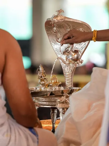 The Abhishekam ritual during the Shat Chandi Homa. The sacred liquids poured over the lingam are collected and distributed as blessed water.