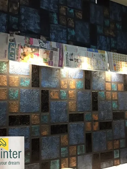 A complex, multi-colored textured wall designed to look like mosaic tiles. This project shows the careful layering of colors and textures to achieve a unique, artistic effect.