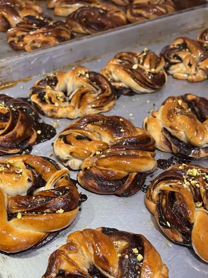 Freshly baked chocolate babka, glistening and sprinkled with pistachios. A special treat from our Christmas menu.