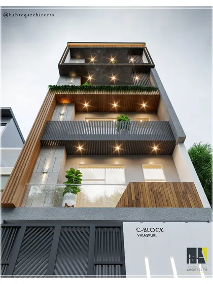 A night view of our upcoming residential project in Vikaspuri, highlighting the impact of strategic lighting. The combination of WPC louvers, grey tiles, and black MS railings creates a dramatic and sophisticated exterior after dark.
