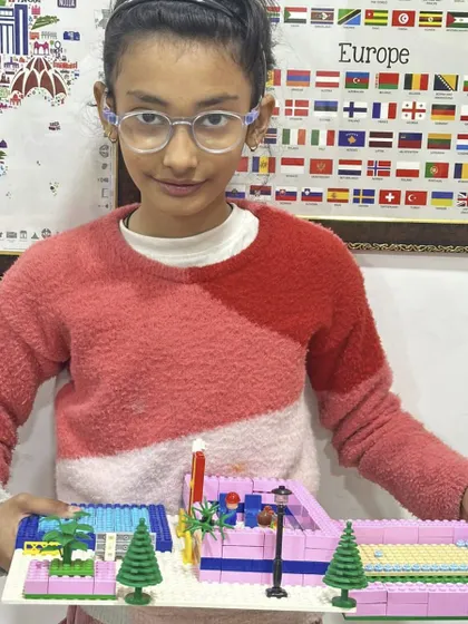 A detailed LEGO creation of a modern house with a swimming pool, showing advanced building techniques and attention to aesthetic detail.
