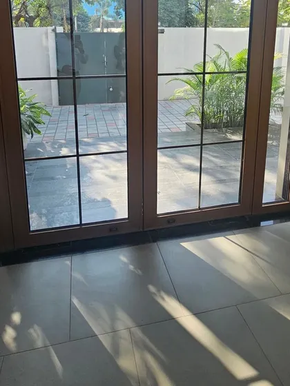 A view from the inside looking out through our Georgian bar doors. The design adds a layer of sophistication to the entrance while framing the outdoor view.
