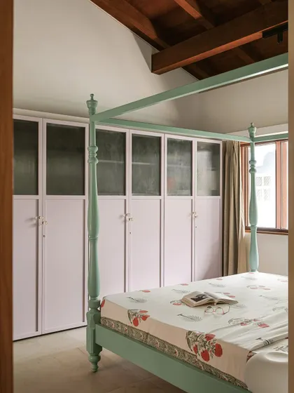 A side view of the bedroom, showing the interplay of colors and the traditional form of the bed, creating a space that feels both rooted and contemporary.