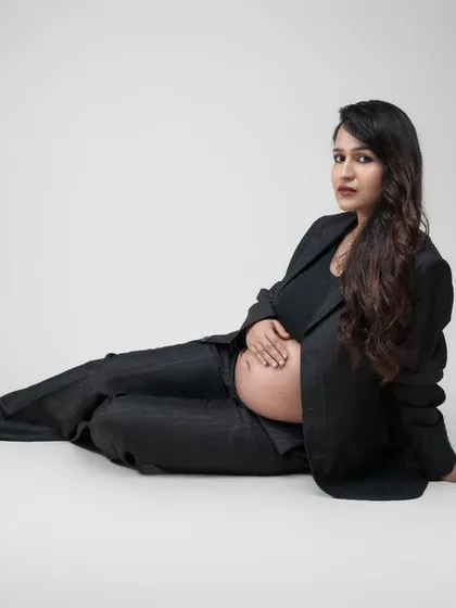 Empowered, fearless, and expecting. This stunning solo maternity shot showcases the perfect blend of elegance and confidence in a modern power suit.