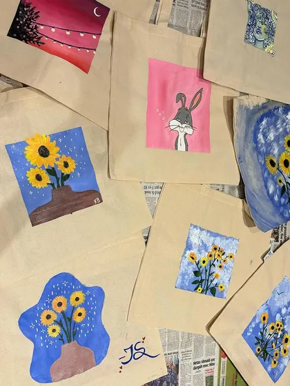 A collection of finished tote bags from a workshop. The variety of designs is a testament to the creativity of our guests.