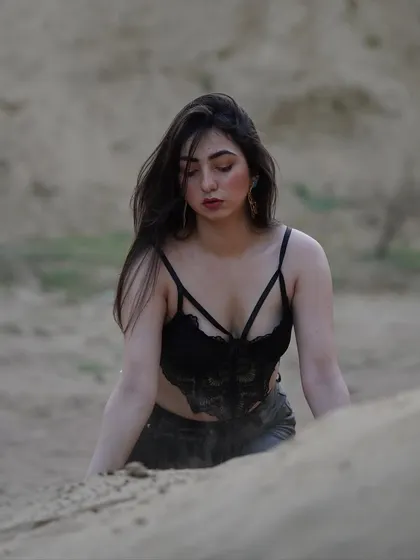 A raw, unedited shot from a desert-themed shoot. This photo captures a moment of quiet intensity, playing with the texture of the sand.
