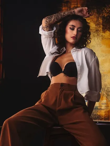 Sometimes the most powerful stories are told in the in-between moments. This raw, unfiltered shot uses moody, dramatic lighting to create a cinematic and fearless fashion portrait.