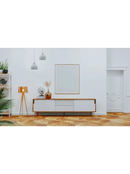A minimalist media console against a clean white wall. This image showcases our "less is more" approach, where simple, well-chosen furniture can make a big impact.