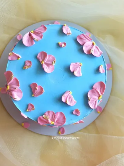 A similar petal-piping technique, this time with pink flowers on a blue base. This was a Chocolate Raspberry cake, perfect for a baby shower.