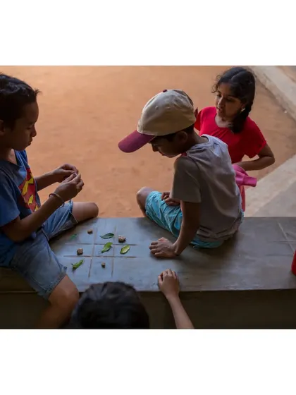 Children at Buddhi School find a quiet corner to play a game using leaves and stones. Our designs often include informal nooks and ledges that encourage spontaneous play and social interaction.