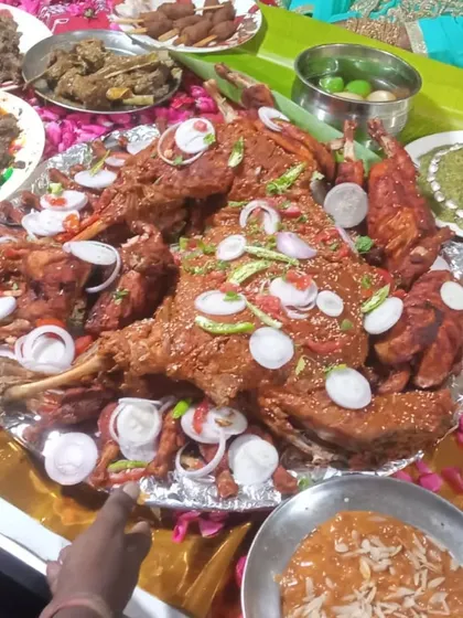 A lavish platter of our non-veg specialities, including roasted chicken, fried starters, and garnished with fresh onions and chillies.