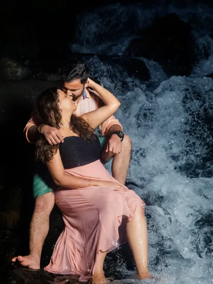 A passionate and artistic shot of the couple by the waterfall at night. We use creative lighting to capture dramatic and memorable pre-wedding images.
