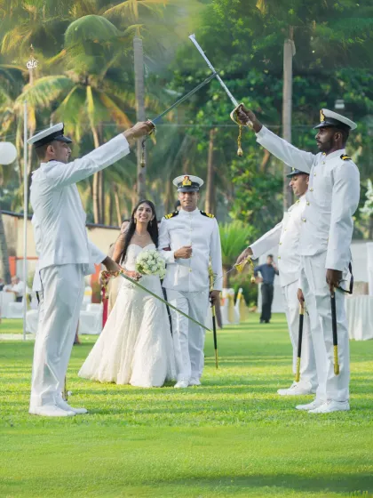 A unique and distinguished moment from a Navy wedding, where the couple walks through a traditional Arch of Sabers ceremony. This photo highlights my experience in capturing specialized and meaningful traditions with elegance.