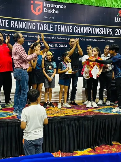 A moment of celebration as Prisha Agarwal is awarded her bronze medal on stage. We support our players at every step, from daily practice sessions at our Gurugram academy to cheering them on at major championships.