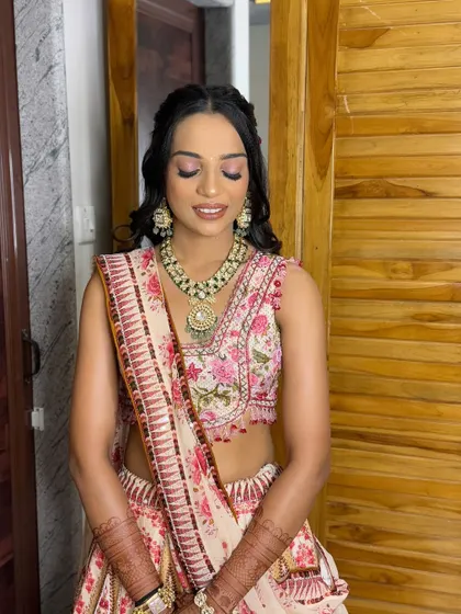 A fresh, floral look for the groom's sister. The pink tones in her makeup perfectly match the embroidery on her beautiful lehenga.