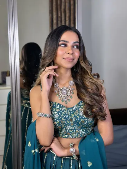 A thoughtful and elegant pose. The makeup is flawless, and the hair is styled to perfection.