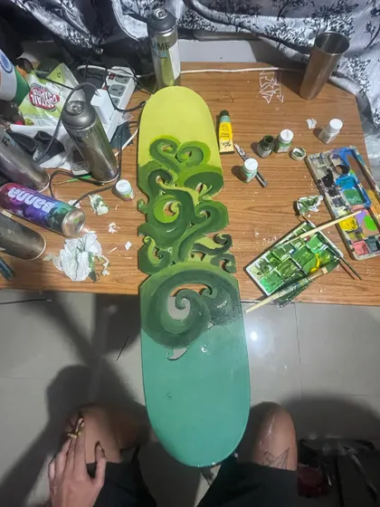 The board during the painting process. My workspace is wherever I can sit down with my paints and get in the zone.