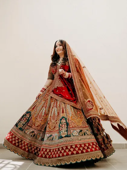 The bride twirls in her magnificent lehenga, the intricate embroidery and rich colors on full display.