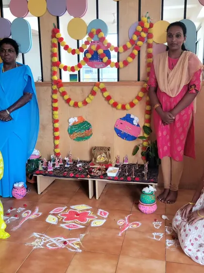 Our dedicated staff members stand by the beautiful Janmashtami display. Their effort and love bring our festive celebrations to life.