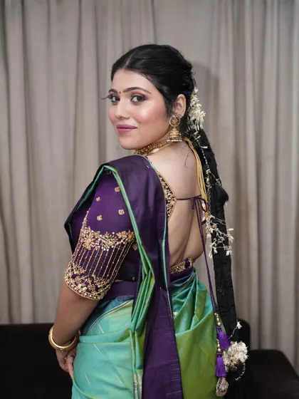 A view of the complete look from the back, showing the traditional long braid adorned with flowers. This highlights how I consider the entire look, including hair, to create a cohesive style.