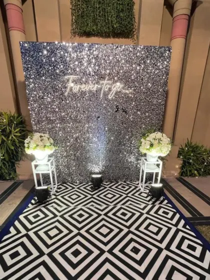 Another angle of the trendy silver sequin photo wall, a popular choice for modern receptions.