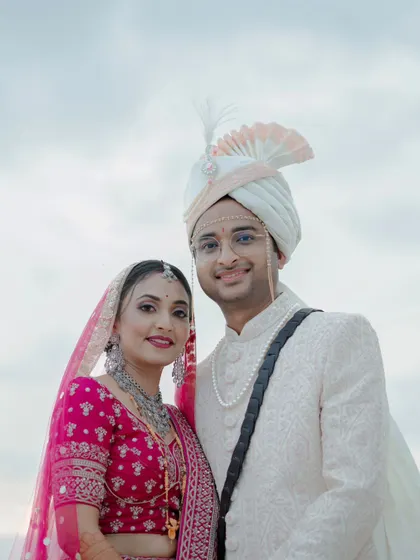 A classic and happy portrait of the North Indian wedding couple, their smiles radiating joy on their special day.