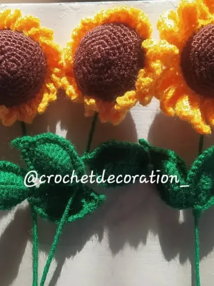 Three single sunflower stems, showing slight variations that make each handmade flower unique.