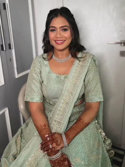 The complete look is elegant and perfect for a wedding guest or bridesmaid. The makeup is balanced and enhances her features without being overpowering.