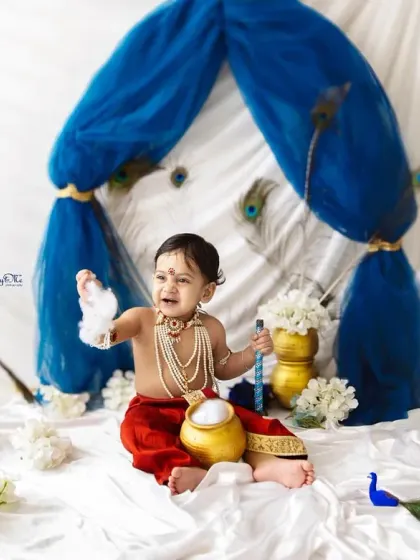 The cutest little Makhan Chor (butter thief). This little Kanha is having a great time with the pot of 'butter' during his Janmashtami photoshoot.