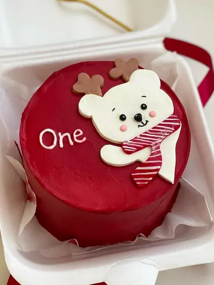 A festive Christmas-themed bento cake. This cute red mini cake features an adorable polar bear wearing a scarf.