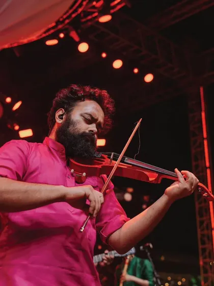 A live performance by a violinist from The Raghu Dixit Project. High-quality live music elevates the atmosphere of any event, making it feel truly special and sophisticated.