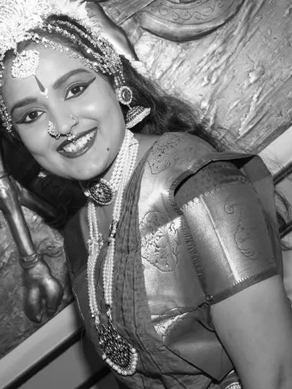 A timeless black and white portrait of the dancer, emphasizing her smile and expression. This artistic choice adds a classic, dramatic feel to the performance portfolio.