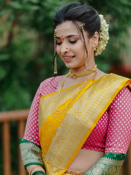 A serene and beautiful portrait. The soft makeup look, paired with a traditional gajra bun, is the epitome of Maharashtrian bridal elegance.