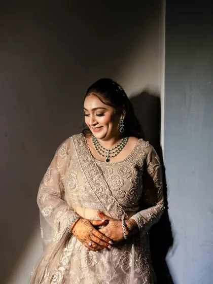 A beautiful portrait of the Sangeet bride. The lighting highlights her dewy makeup and the intricate details of her lehenga.