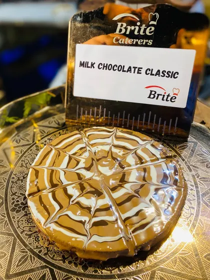 The Milk Chocolate Classic waffle, presented on an ornate silver plate.