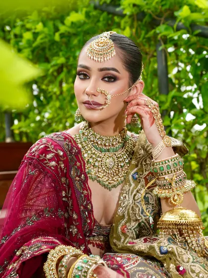 Grace, glow, and grandeur in one frame. This angle highlights the intricate details of her jewellery and the flawless application of her makeup, from the defined eyes to the radiant complexion.
