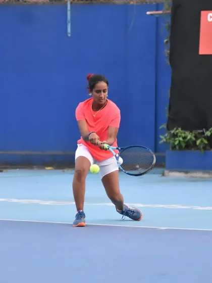 Connecting with the ball for a low forehand. Mastering shots like these requires precise footwork and timing, which are core elements of my tennis drill sessions.