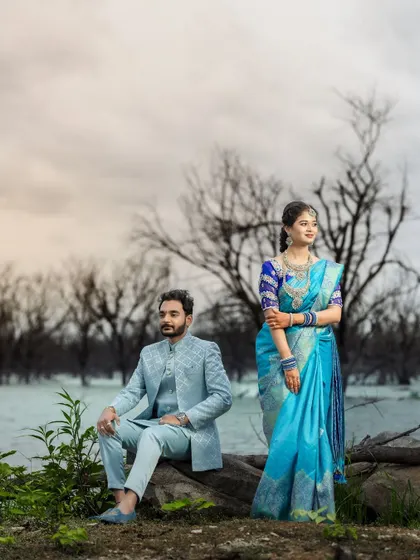 A serene portrait of a couple by the lake. The soft lighting and calm water create a peaceful and romantic atmosphere.