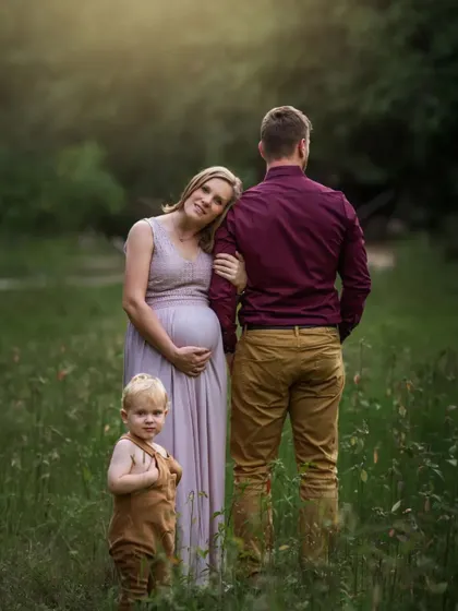 A family portrait that is also a maternity announcement. The way the little one looks on, with his parents expecting another, tells a story of a family on the cusp of a new chapter.