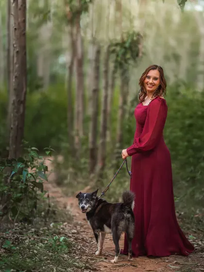 A woman in a beautiful gown, walking her dog through a forest path. This image feels like a scene from a storybook, combining elegance with the simple joy of a walk with a pet.