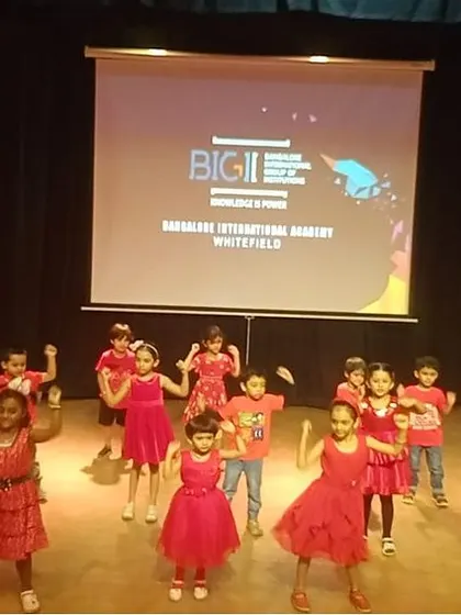 A large group of our little campers in red perform an energetic dance routine for their parents.