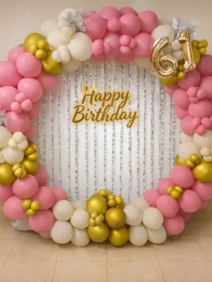Celebrating 61 years with this elegant circular balloon backdrop. I used a soft palette of pink, white, and chrome gold balloons, with a silver fringe curtain and gold "Happy Birthday" sign to mark the special milestone.