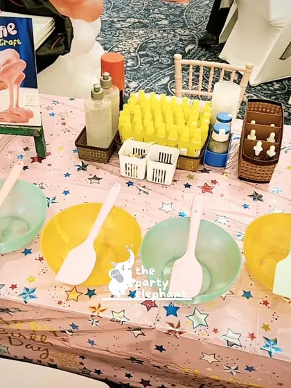 A slime-making station, complete with colorful bowls and all the necessary ingredients. This sensory activity is always a huge hit with kids of all ages.