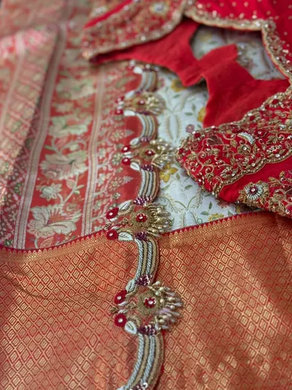 A red bridal blouse with a unique back design featuring shell and bead work.