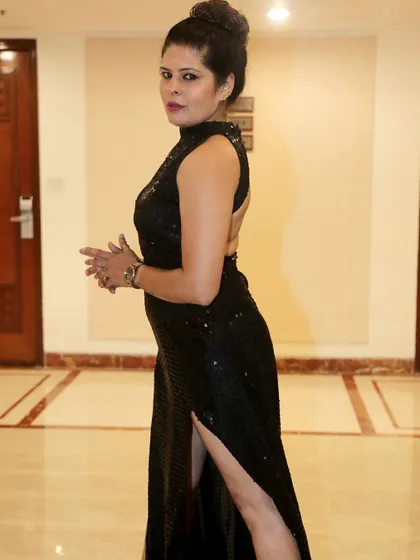 A side view of the black sequin gown, showing its backless design.