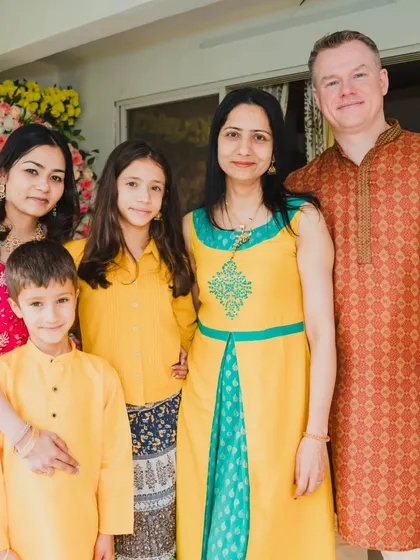 A lovely family portrait taken during the Haldi ceremony, capturing the joy of the multicultural family coming together.
